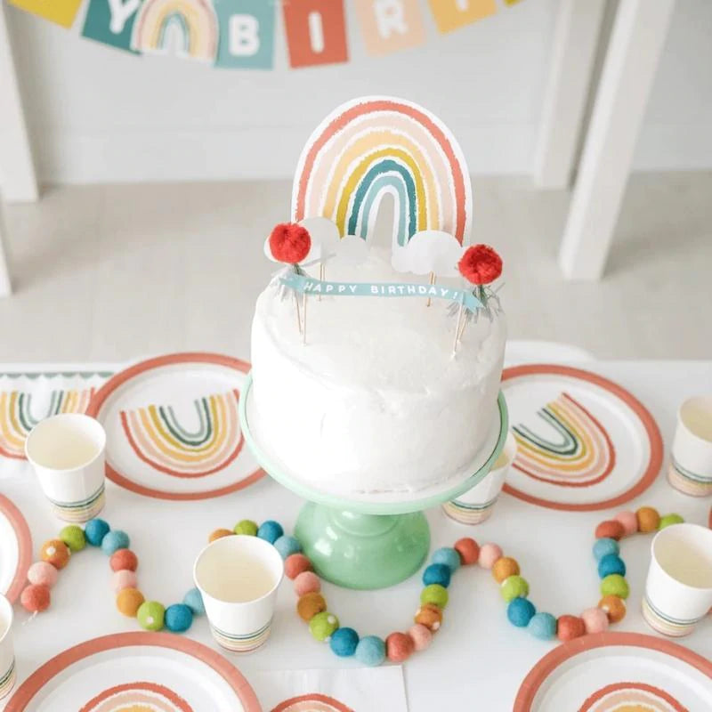 Cake with rainbow cake topper displayed