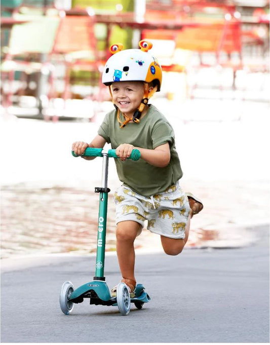 Boy riding a Micro Mini Deluxe scooter
